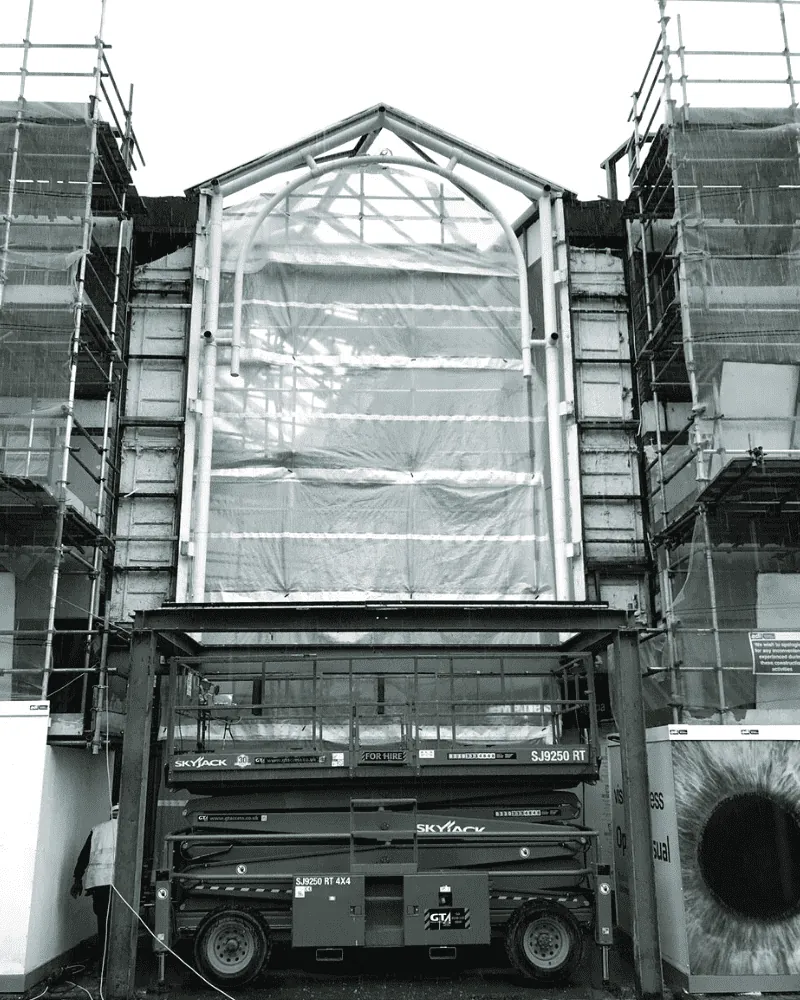 Curtain wall glazing being removed with MEWP access