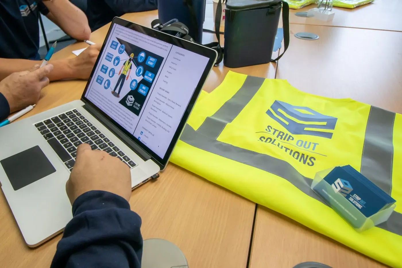 Site-specific RAMS being reviewed on screen alongside SOS hi-vis