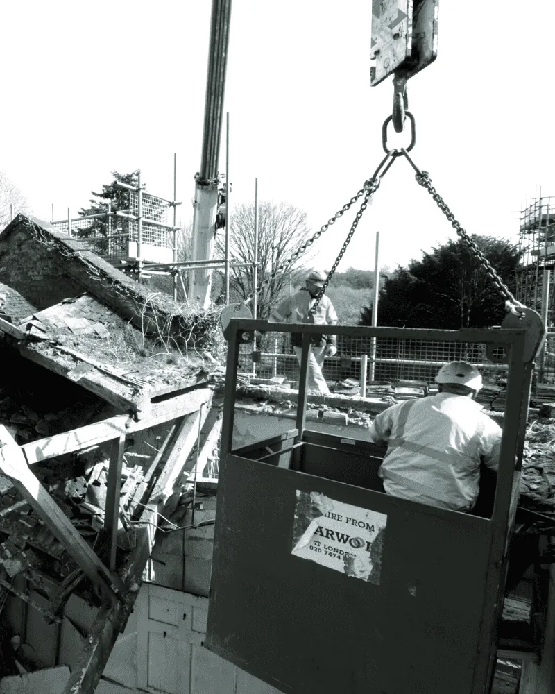 SOS operatives working from a crane man-basket on a listed building soft strip